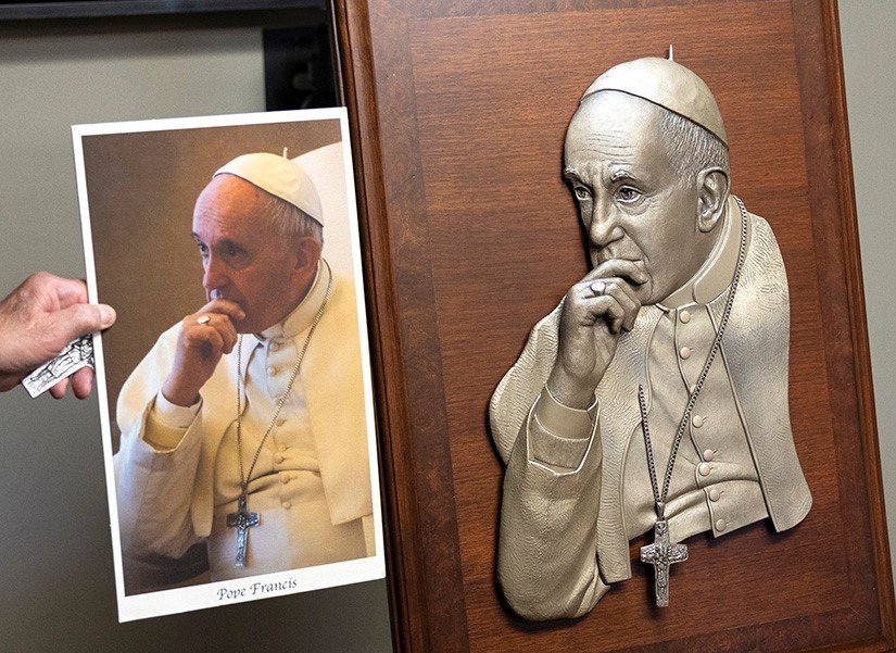 Sculptor Don Wiegand, left, and Archbishop Mitchell T. Rozanski of St. Louis talk about Mr. Wiegand’s sculpture of Pope Francis on Aug. 1 at the Cardinal Rigali Center in Shrewsbury.